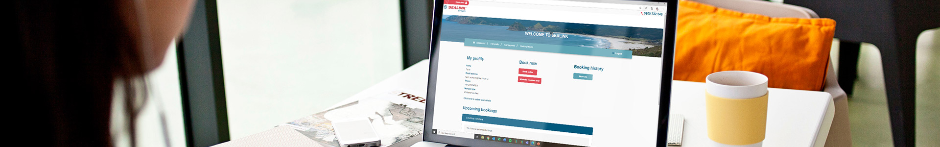 SeaLink booking information header image - woman's hands working on computer