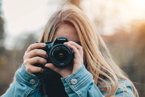 Blonde woman with camera