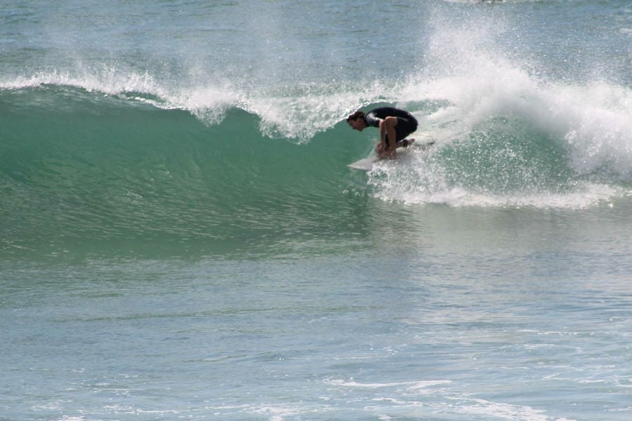 Great Barrier Island local resident surfing at Medlands beach