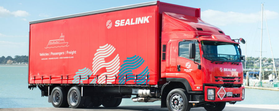 SeaLink curtainsider truck parked at Half Moon Bay marina