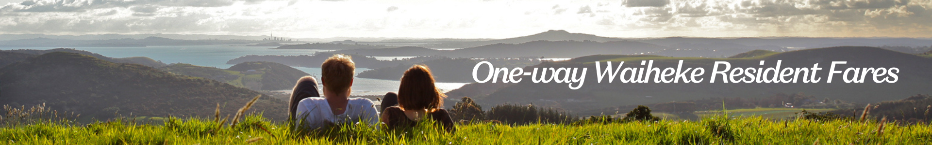 Couple enjoying the view of Auckland city from Waiheke Island 